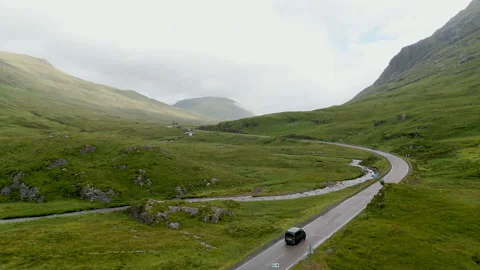 Low aerial pan left, A82 Ballachulish, Glencoe, Scotland, misty, cars Stock Footage 204925206