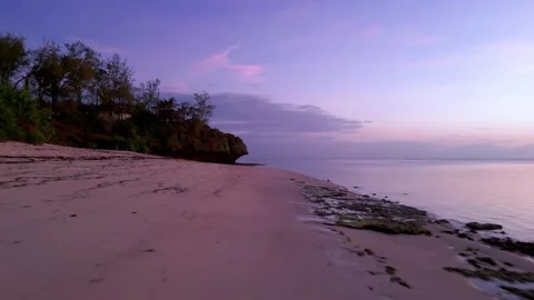 Low Aerial pull at sunrie on a paradise beach Video stock 245004655