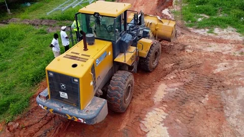 Low aerial rocket pull away over bulldozer at solar plant after rain in wet 스톡 동영상 297983337