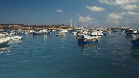 Low Aerial shot flying between fishing boats in Marsaxlokk Stock Footage 90649562