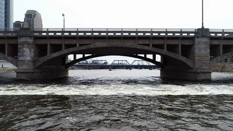 Low aerial shot going under a bridge on the grand river Stock Footage 89510227