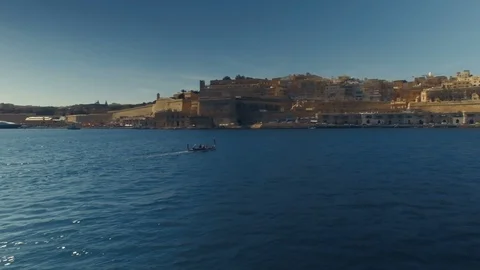 Low Aerial shot orbiting around a maltese Luzzu Stock Footage 91101057