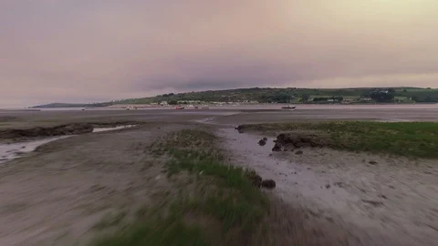 Low Aerial shot over grass flying towards the ocean Stock Footage 90532934