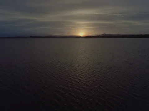 Low aerial sunset flight pulling up over the lake at Mungo Brush National Park. Stock Footage 77980968