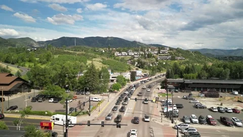 Low aerial of traffic at intersection in Steamboat Springs Colorado in summer Stock Footage 313632431