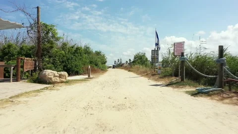 Low aerial video on a path between the beach and fish ponds Stock Footage 238438759