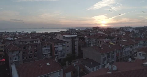 Low aerial view above rooftops of Istanbul on the asian side towards Haydarpasa Stock Footage 93110627