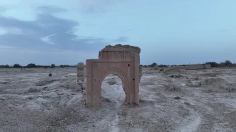 Low Aerial View of Ancient Mud Brick Gateway Arch at Sijilmassa Ruins in Stock Footage 345523565