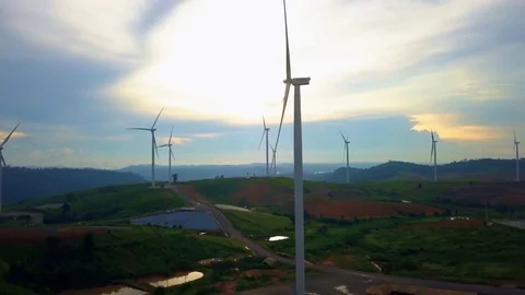 Low aerial view of cluster of wind turbines in green hillside,Thailand Video stock 79876224