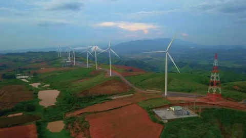 Low aerial view of cluster of wind turbines in green hillside,Thailand Video stock 79876569