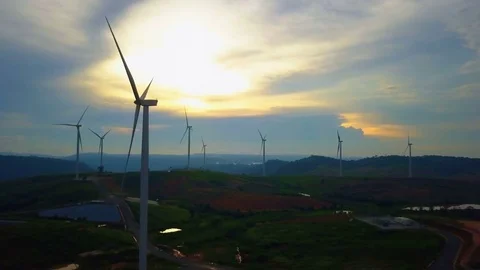 Low aerial view of cluster of wind turbines in green hillside,Thailand Video stock 79876659