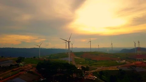 Low aerial view of cluster of wind turbines in green hillside,Thailand Video stock 79876949