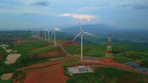 Low aerial view of cluster of wind turbines in green hillside,Thailand Video stock 79877004