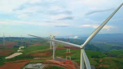 Low aerial view of cluster of wind turbines in green hillside,Thailand Stock Footage 79877475