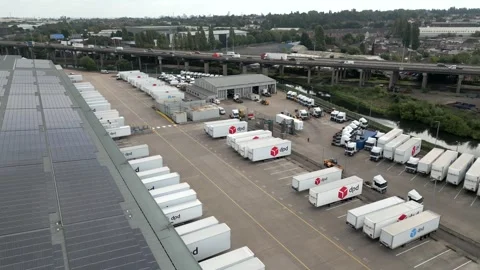 Low aerial view of a DPD logistics and storage yard Stock Footage 247623031