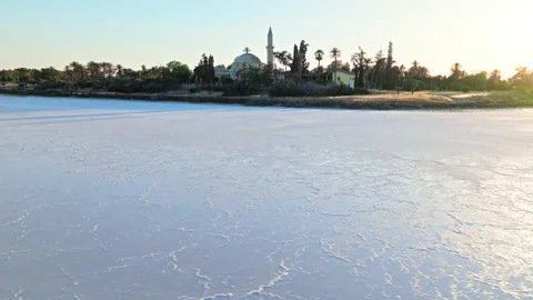 Low aerial view of Larnaca Salt Lake in Cyprus. Stock Footage 341539393