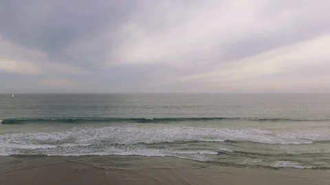 Low Aerial view of Ocean and Pier at the beach Stock Footage 88838409