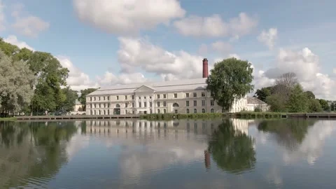 Low aerial view of an old quality building in the expanse of water. Stock Footage 205739754