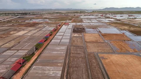 Low Aerial View of Salt Fields and Red Roof Sheds, Kampot Cambodia Stock-Footage 347297867