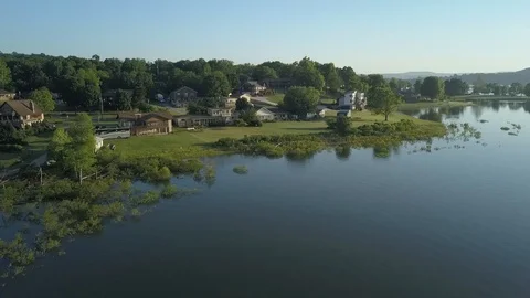 Low Altitde aerial view of lake home community Stock Footage