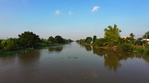 Low altitude aerial flight over calm rural river in golden late afternoon sun Stock-Footage 342926647