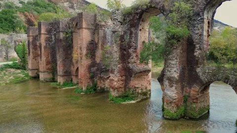 Low Altitude Aerial Pullback from Nicopolis Roman Aqueduct to Louros River Stock Footage 331331918