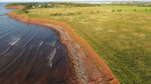 Low altitude areal view of red sand and meadow shoreline in the afternoon Video stock 113869019