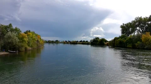 Low altitude drone clip A calm river with trees in the background Stock Footage 328958342