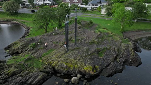 Low altitude drone flight above rocky island with Sverd i Fjell monument. Stock Footage 328131351