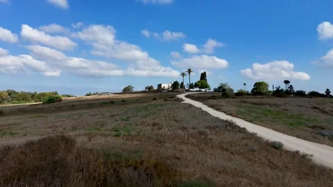 Low Altitude Drone Flight Across Open Fields Toward Isolated Historic Building Stock Footage 337742290