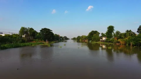 Low altitude drone flight along quiet rural canal in Mekong Delta Stock-Footage 342926679