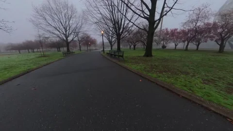 A low altitude drone flight in Flushing Meadows Corona Park on a foggy morning Stock Footage 333267749