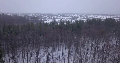 Low altitude drone flight over a snowy suburban neighborhood. Stock Footage 83735677