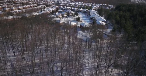 Low altitude drone flight over a snowy suburban neighborhood. Stock-Footage 83765025