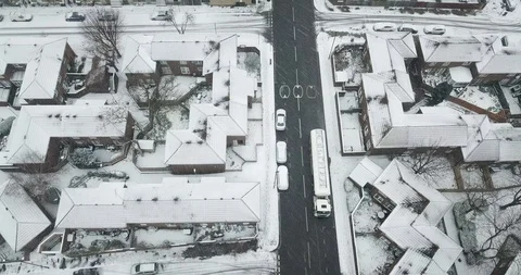 Low altitude drone flight over a road in South London, England in a snowstorm. Stock Footage 87168586
