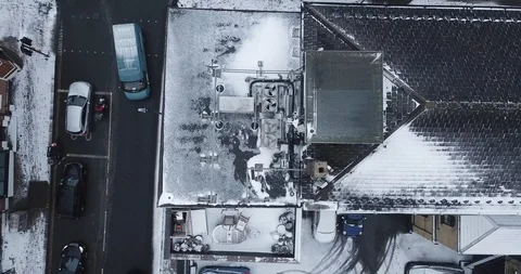 Low altitude drone flight over a road in South London, England in a snowstorm. Video stock 87168662