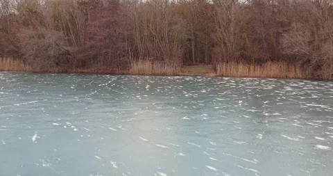 Low Altitude Drone Flight Over Frozen Oberwaldsee With Frankfurt Skyline Ho.. Stock Footage 325729463