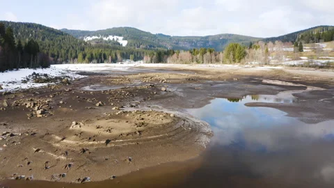 Low altitude drone flight over dry lakebed with textures and shallow water Stock-Footage 332048392