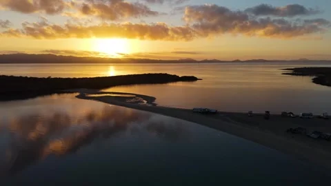Low Altitude Drone Flight Over Silhouetted Sandbar Spit Tracking Majestic Stock Footage 338432919