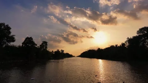 Low altitude drone flight over river into bright glowing sunset Stock-Footage 343606643