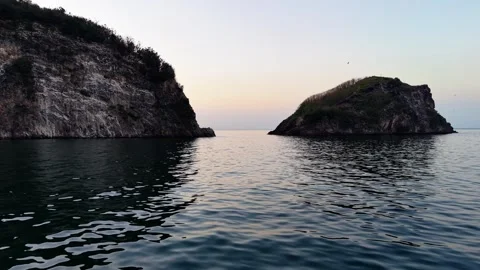 Low Altitude Drone Flight Passing Between Two Islands Over Sea Surface Stock Footage 334239699