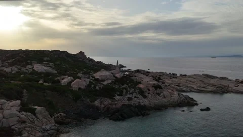 Low Altitude Drone Orbit Over Sea Around Lighthouse Sardegna Sunset Vídeo Stock 333400050