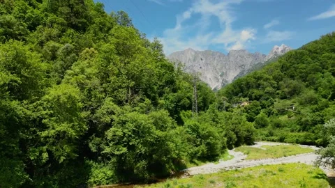 Low Altitude Drone Pan Over River and Mountain Landscape in Tuscany, Italy .. Stock Footage 329054430