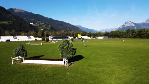 Low altitude drone pass over equestrian arena in Maienfeld Stock Footage 331880883