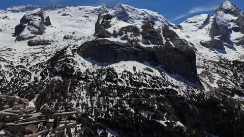 Low Altitude Drone Push Over Snowy Ridge Facing Colossal Limestone Massi Stock Footage 339529013
