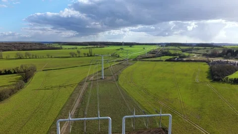Low altitude drone push shot showing sleek T-pylon designs at National Grid Stock Footage 342075561