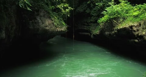 Low Altitude Drone Shot of River Flowing Over Rocks in Tropical Canyon Stock-Footage 332491300