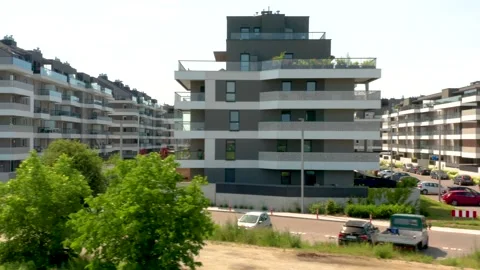 Low altitude drone tracking shot along modern grey and white apartment buildings Stock Footage 312593423