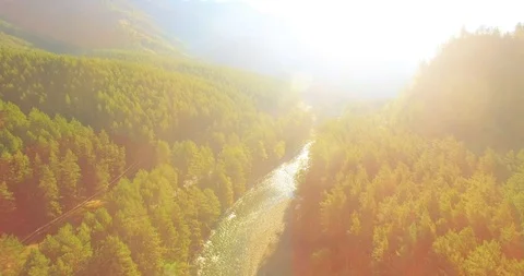 Low altitude flight over fresh fast mountain river with rocks at sunny summer Stock Footage 110933381