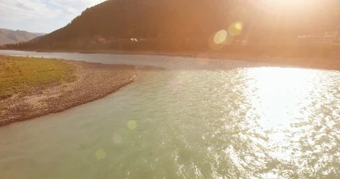 Low altitude flight over fresh fast mountain river with rocks at sunny summer Stock Footage 111909205